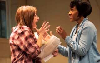 actresses on stage in a play