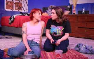 two actors on stage in a dramatic play