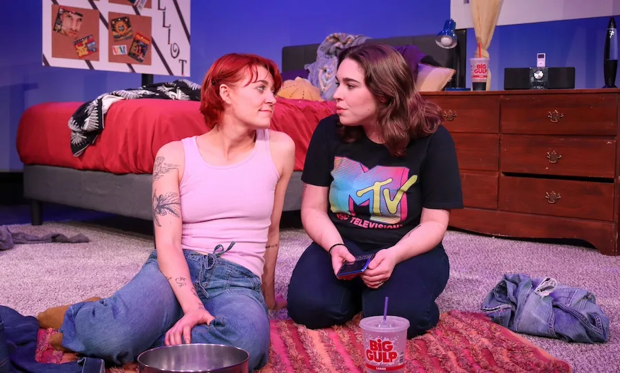two actors on stage in a dramatic play