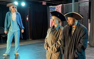 actors on stage in a comedy