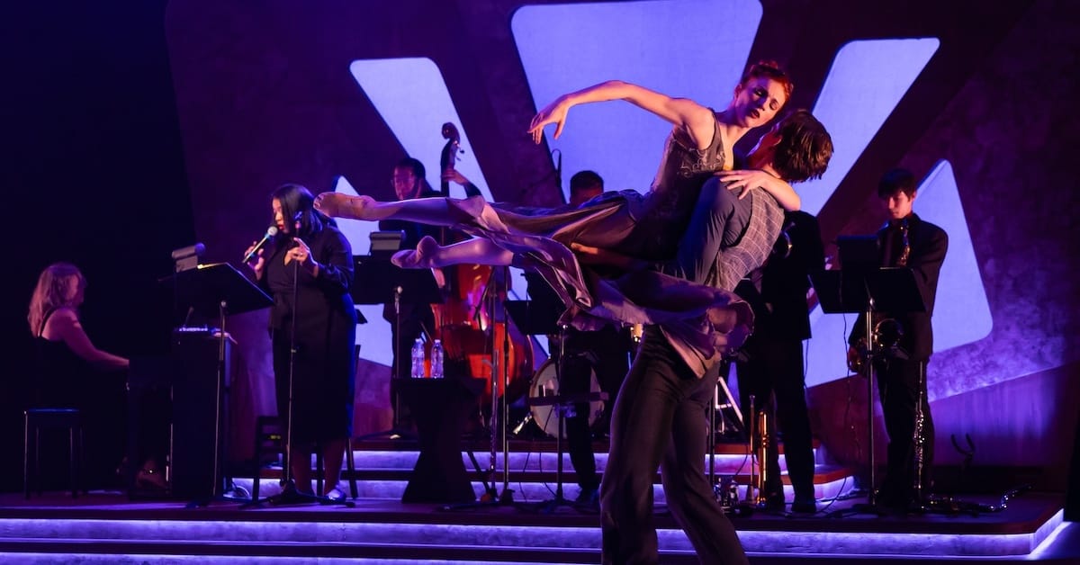 dancers on stage with band
