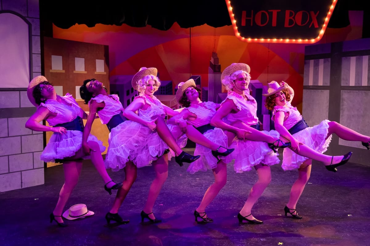 actors on stage in a musical