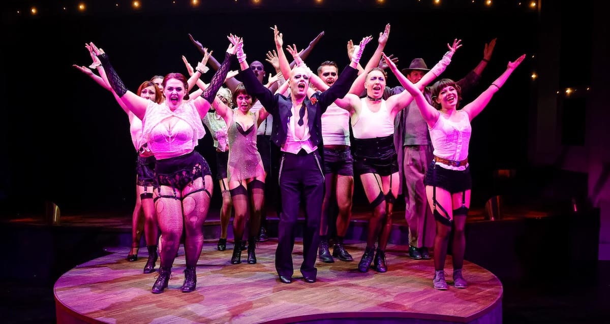 actors onstage in a musical