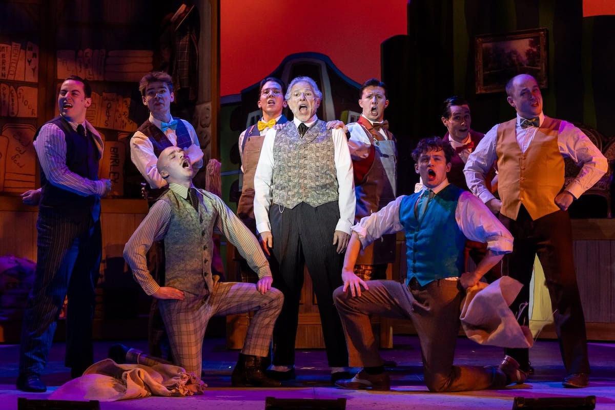 actors onstage in a musical 