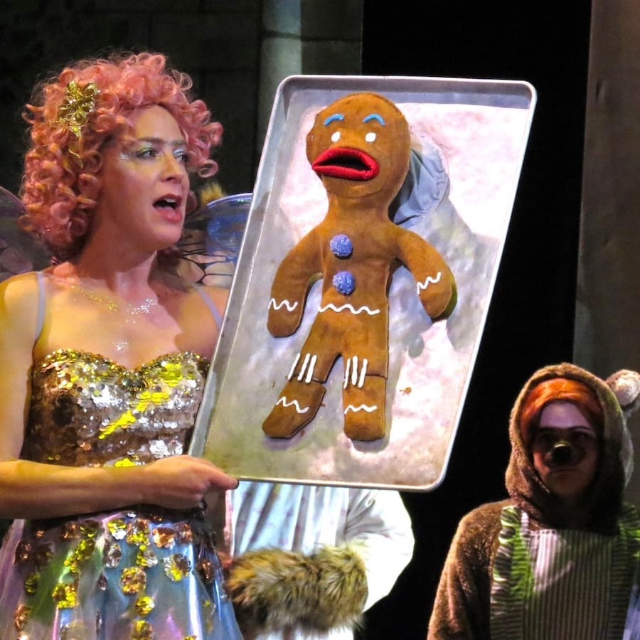 actors onstage in a musical 