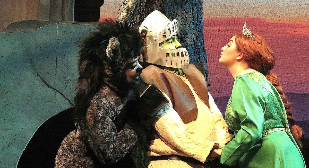 actors onstage in a musical