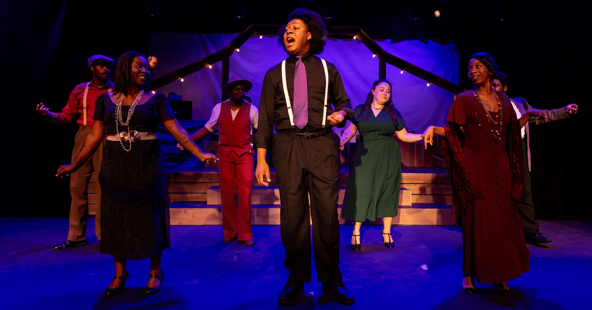 actors onstage in a musical