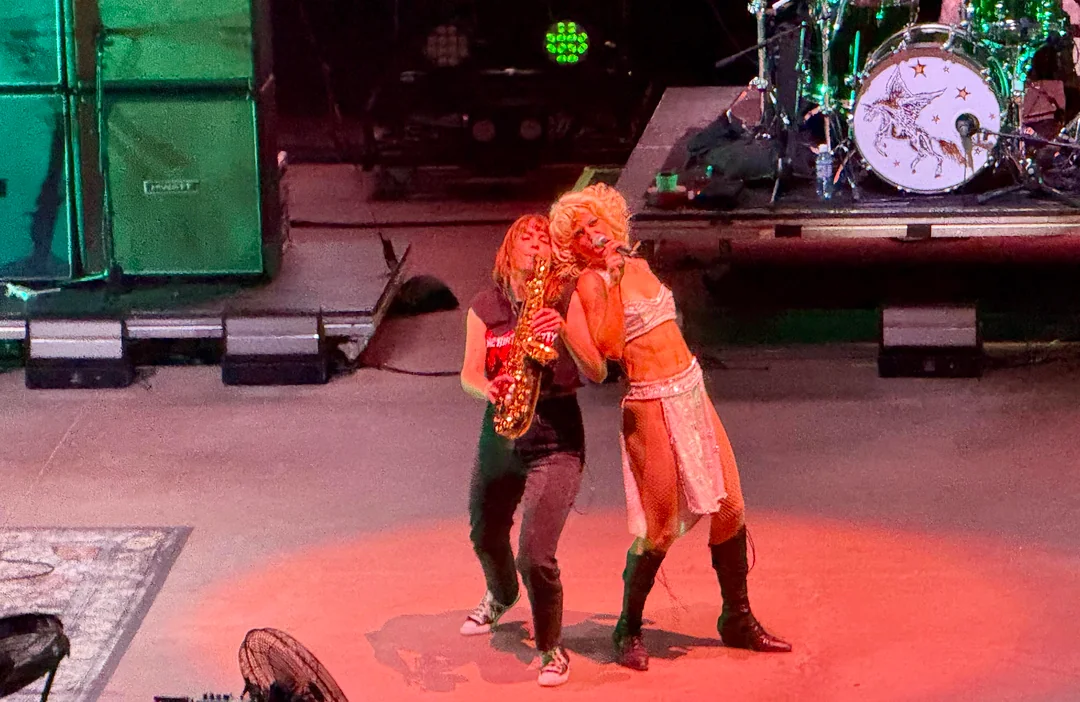Two people perform onstage together