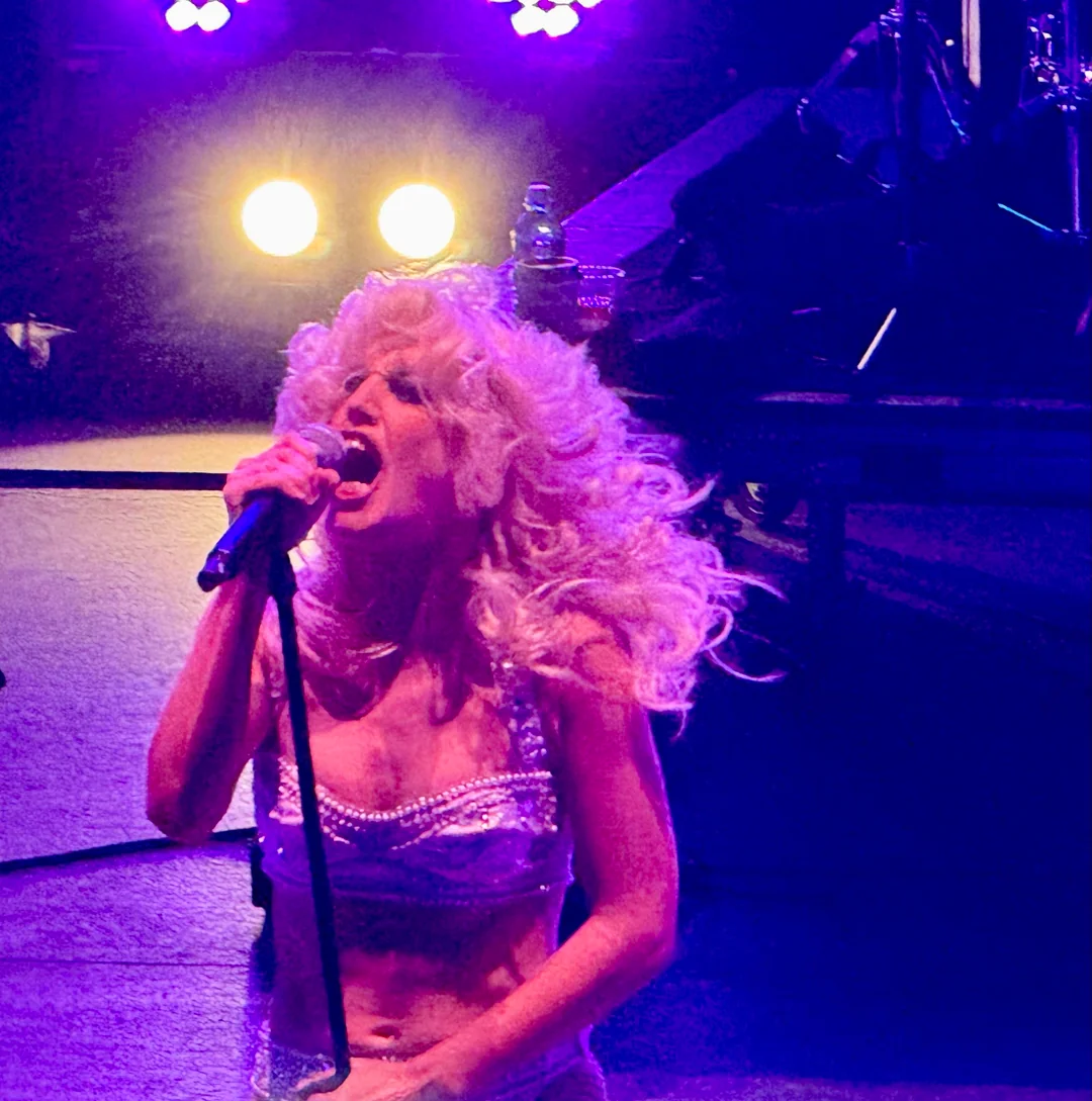 Woman sings onstage