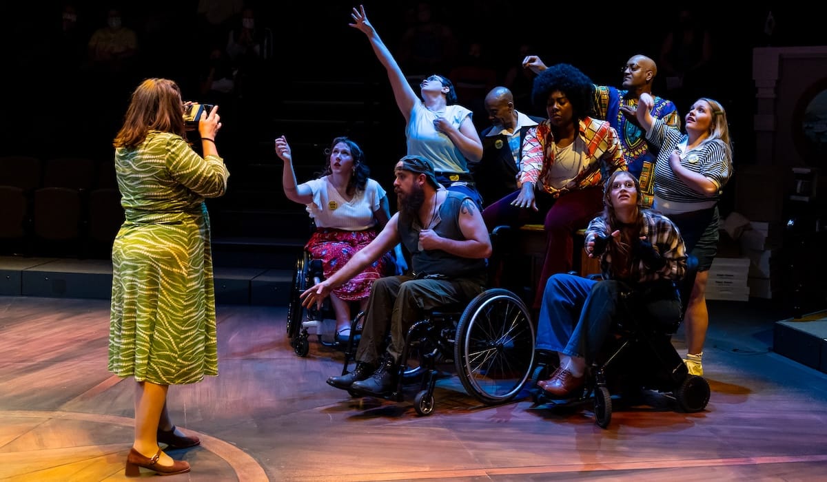 '504: The Musical' sings the messy work of solidarity 2 A person takes a photo of disabled people