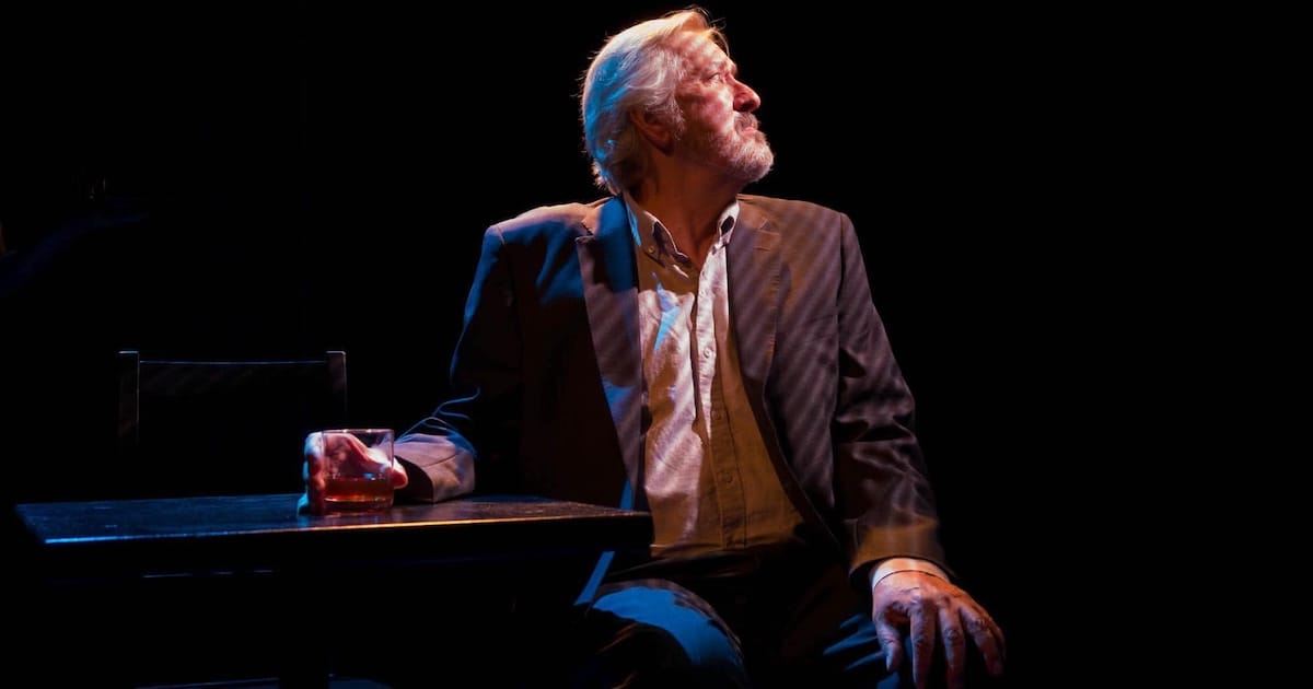 A man sits at a bar