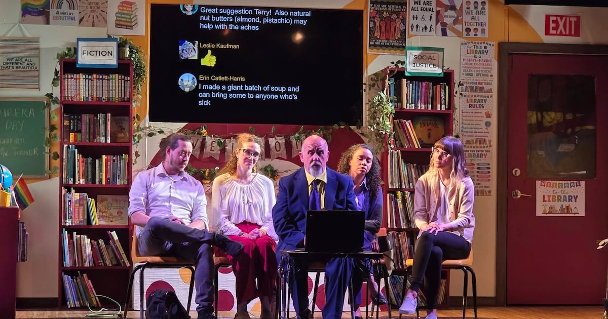 People gather in front of a computer, and a screen with comments runs behind them