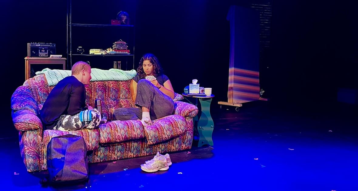 Two people sit on a couch