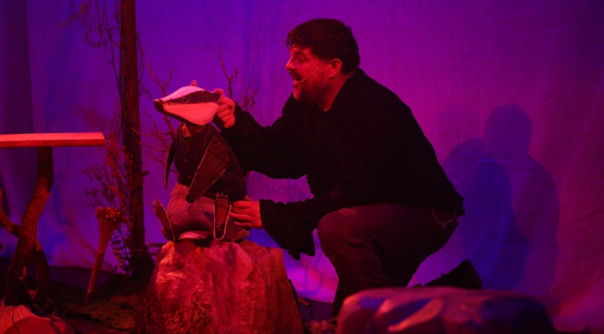 A man uses a handheld badget puppet in Brindlewood
