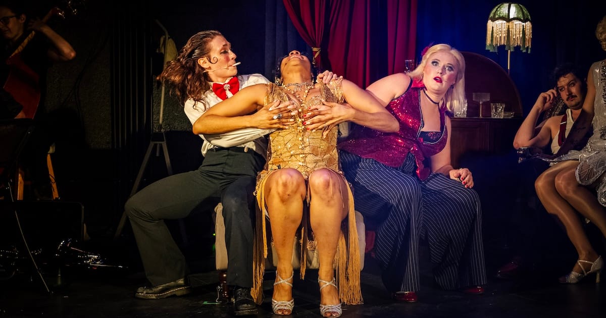 A woman throws herself down on the same couch as two others who looks surpised