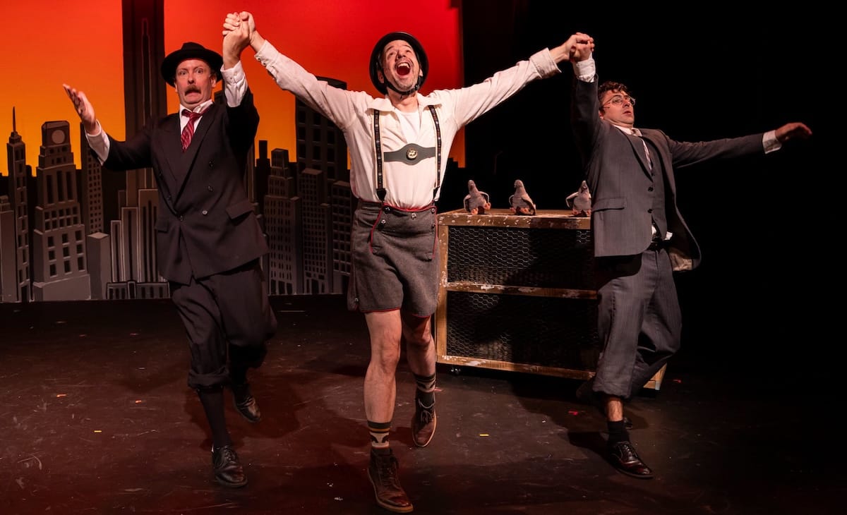 Two men dance with a German man uncomfortably in The Producers