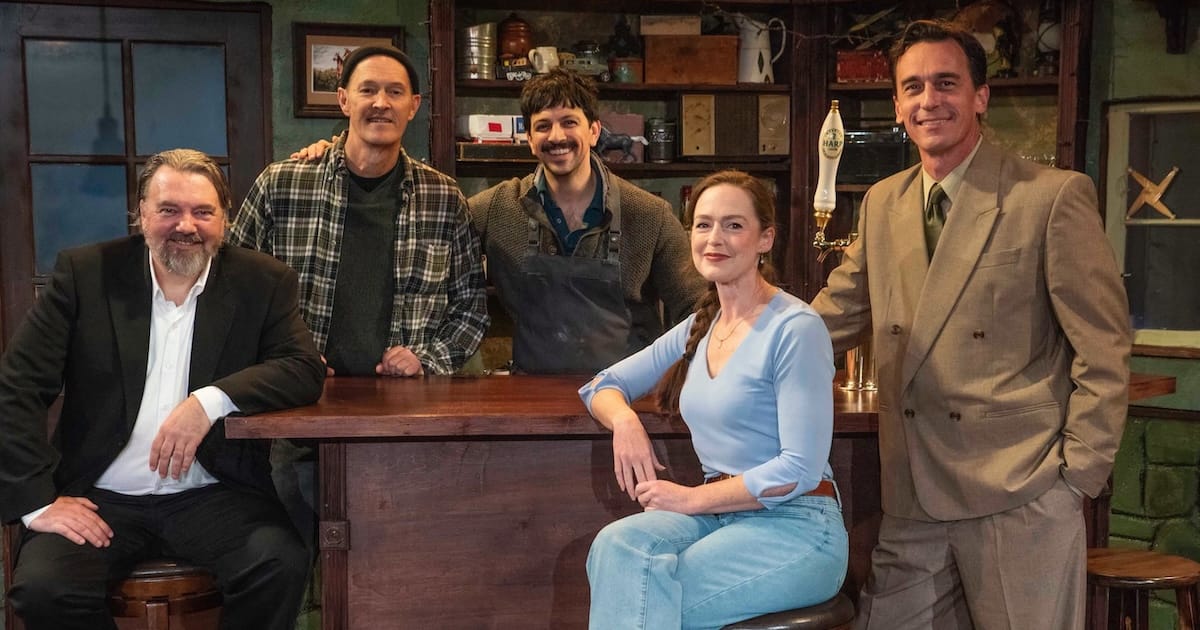 Five people gather around a bar in a play called "The Weir"