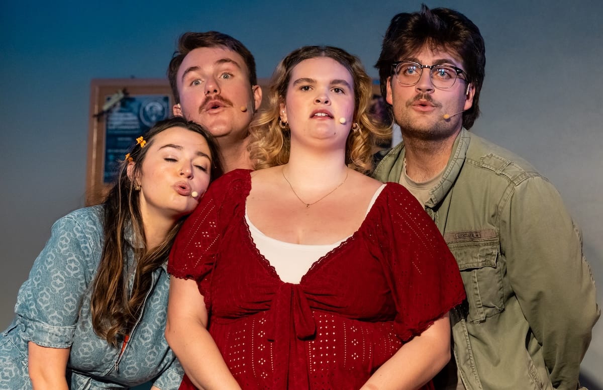 Four people sing together in 