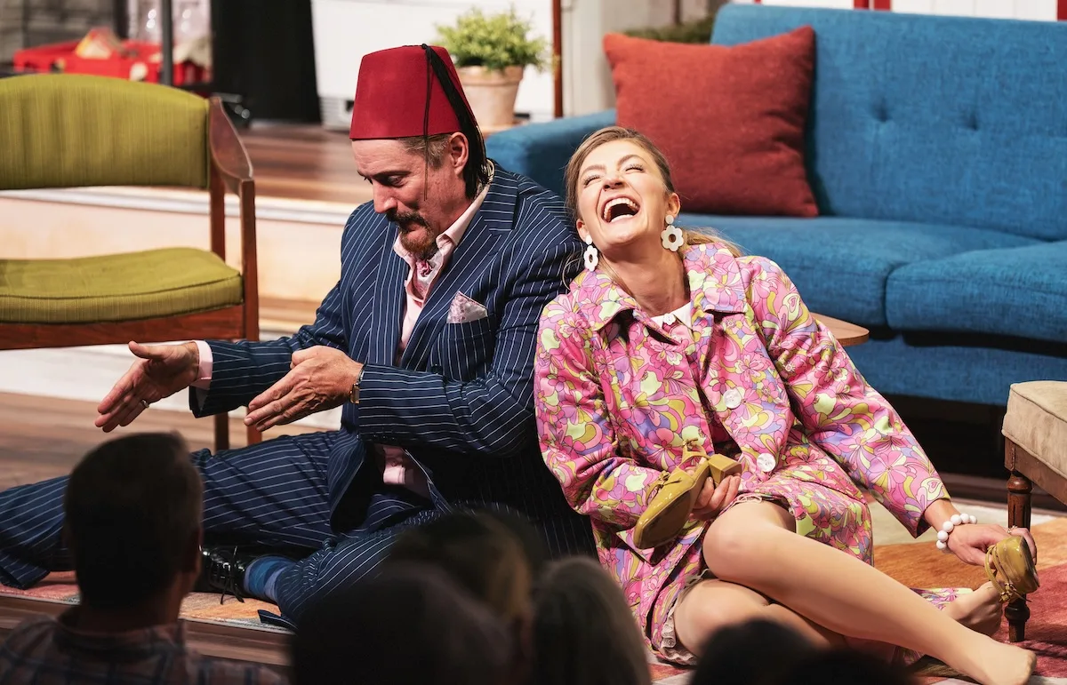 Two people laugh together during a scene in "Barefoot in the Park"