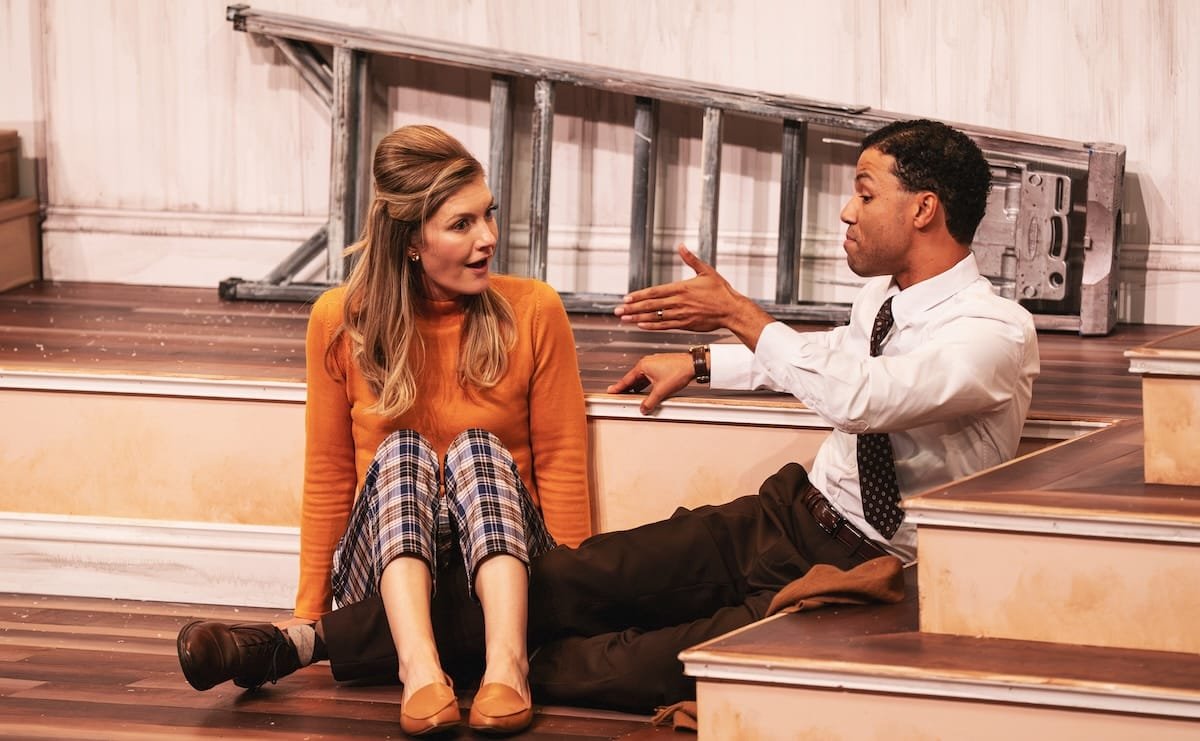Two people talk on the ground during a scene from "Barefoot in the Park"