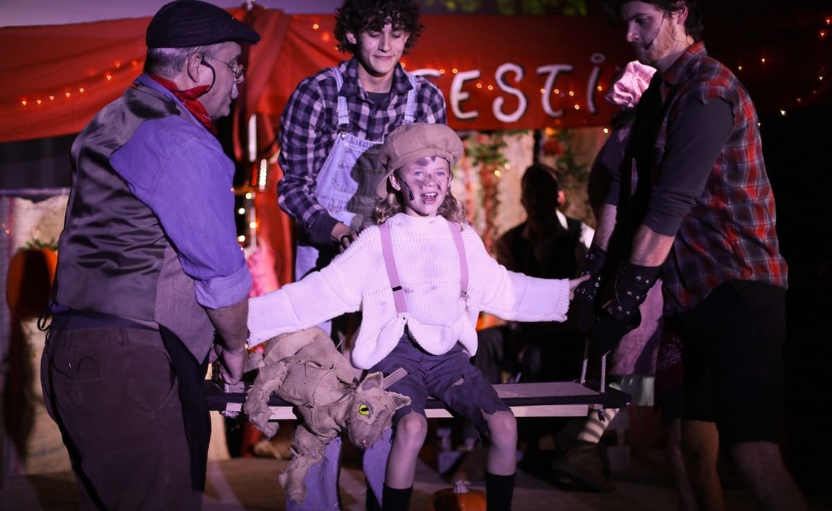 ‘The Pumpkin Kid’ glows at the Historic Elitch Theatre 2 Three men lift a little girl on a makeshift swing in