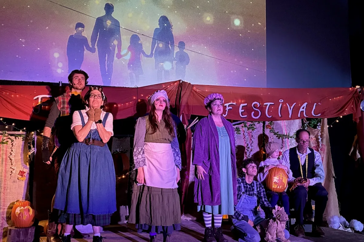 Actors look sad as projections of a happy family play above them