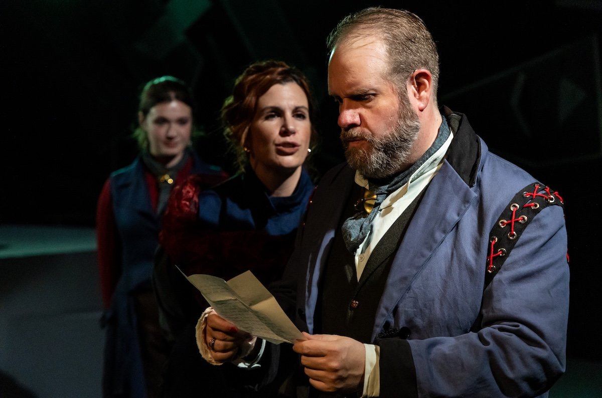 People stare at a man in a scene from Vintage Theatre's Dr. Jekyll & Mr. Hyde