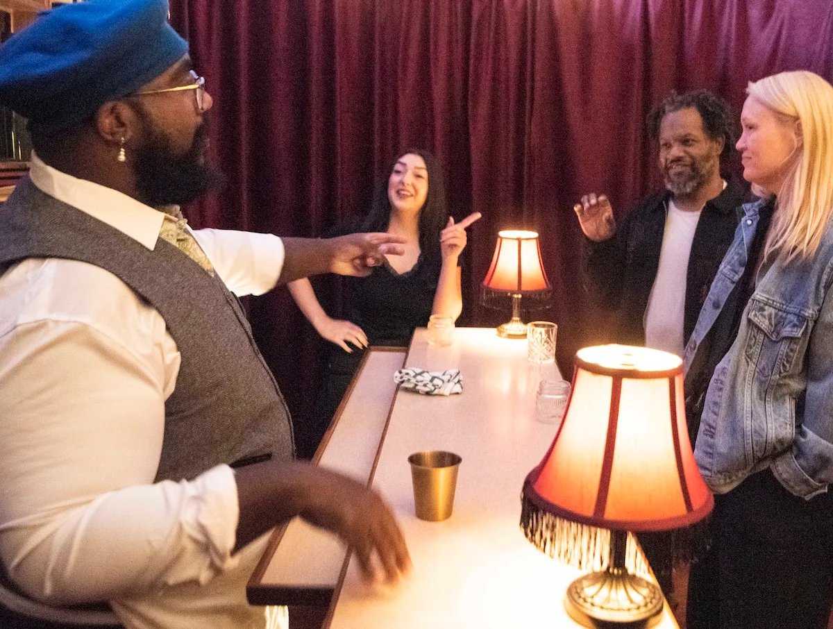 Can 'SIP' help reinvent immersive theatre in Colorado? 4 Four people chat around a table with lamps