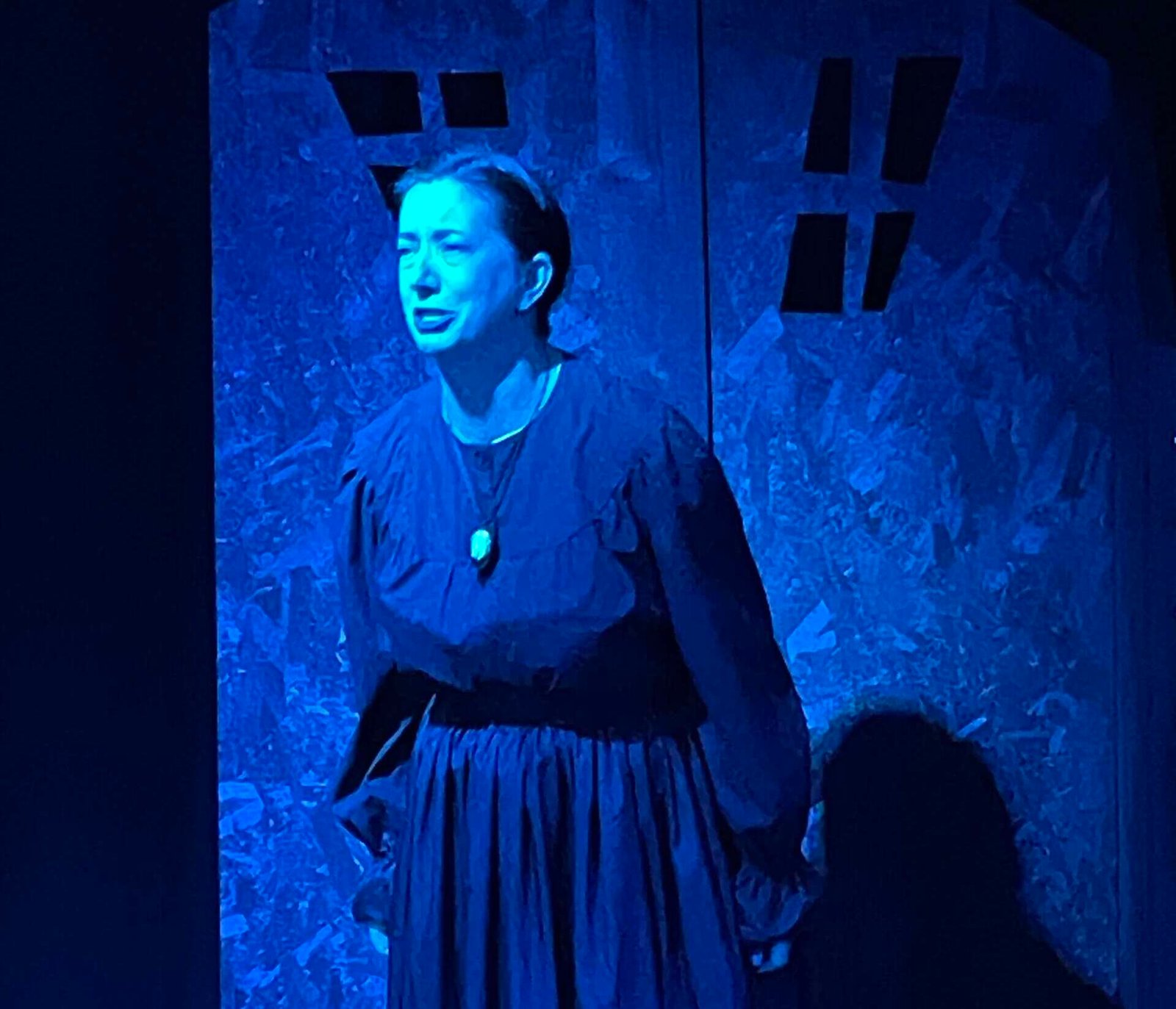 A woman looks scared during a spooky scene in 